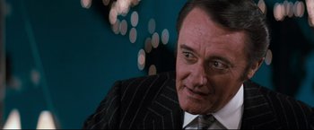 Movie still from “Superman III” (1983), directed by Richard Lester – A person wearing a suit and tie; Close Up shot, Over the shoulder angle