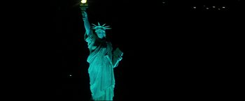 Movie still from “Superman III” (1983), directed by Richard Lester – The statue of liberty is lit up in green; Extreme Wide shot, Low angle