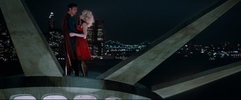 Movie still from “Superman III” (1983), directed by Richard Lester – A man and a woman dancing on top of a building; Wide shot, Overhead angle