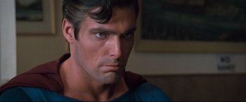 Movie still from “Superman III” (1983), directed by Richard Lester – A man with a serious look on his face; Close Up shot, Over the shoulder angle