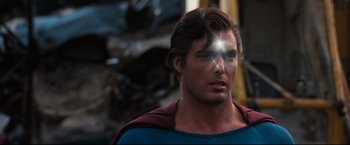 Movie still from “Superman III” (1983), directed by Richard Lester – A person wearing a superman costume; Close Up shot, Over the shoulder angle