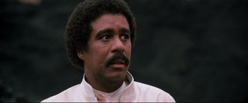 Movie still from “Superman III” (1983), directed by Richard Lester – A person with a mustache; Close Up shot, Low angle