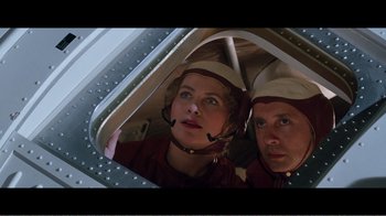 Movie still from “Superman IV: The Quest for Peace” (1987), directed by Sidney J. Furie – A man and a woman are looking into a mirror; Medium shot, Overhead angle