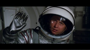 Movie still from “Superman IV: The Quest for Peace” (1987), directed by Sidney J. Furie – A man in a spacesuit and helmet in a space suit; Close Up shot, Overhead angle