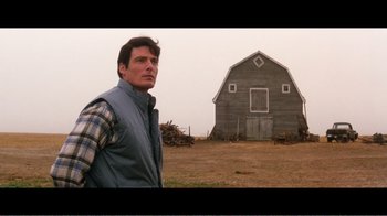 Movie still from “Superman IV: The Quest for Peace” (1987), directed by Sidney J. Furie – A man standing in front of an old barn; Medium shot, Over the shoulder angle