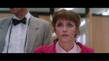 Movie still from “Superman IV: The Quest for Peace” (1987), directed by Sidney J. Furie – A person wearing a suit and tie; Medium shot, Over the shoulder angle