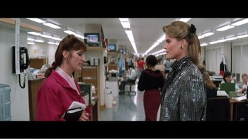 Movie still from “Superman IV: The Quest for Peace” (1987), directed by Sidney J. Furie – Two women talking in an office setting; Medium shot, Over the shoulder angle