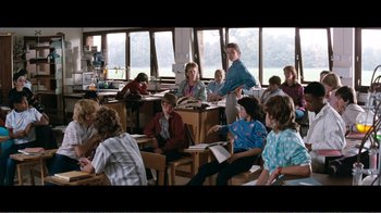 Movie still from “Superman IV: The Quest for Peace” (1987), directed by Sidney J. Furie – A group of people sitting in a room; Wide shot, High angle
