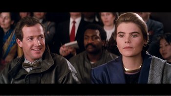 Movie still from “Superman IV: The Quest for Peace” (1987), directed by Sidney J. Furie – A group of people sitting in front of each other; Close Up shot, Over the shoulder angle