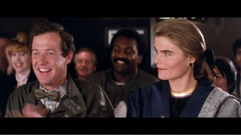 Movie still from “Superman IV: The Quest for Peace” (1987), directed by Sidney J. Furie – A group of men and women sitting next to each other; Close Up shot, Low angle