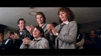 Movie still from “Superman IV: The Quest for Peace” (1987), directed by Sidney J. Furie – A group of people standing next to each other clapping; Medium shot, Over the shoulder angle