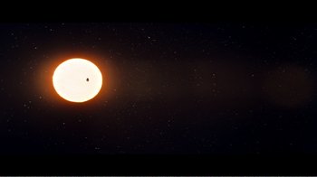 Movie still from “Superman IV: The Quest for Peace” (1987), directed by Sidney J. Furie – The sun is shining brightly in the dark sky at night; Extreme Wide shot, Overhead angle
