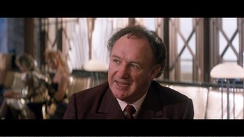 Movie still from “Superman IV: The Quest for Peace” (1987), directed by Sidney J. Furie – An older man wearing a suit and tie; Close Up shot, Over the shoulder angle