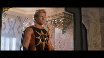 Movie still from “Superman IV: The Quest for Peace” (1987), directed by Sidney J. Furie – A man with blond hair wearing a black and gold outfit; Medium shot, Low angle