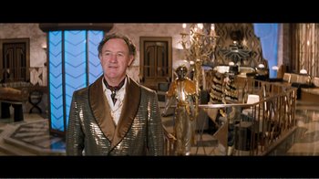 Movie still from “Superman IV: The Quest for Peace” (1987), directed by Sidney J. Furie – A man standing in front of a display of statues; Medium shot, High angle