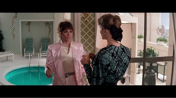 Movie still from “Superman IV: The Quest for Peace” (1987), directed by Sidney J. Furie – Two women are talking in front of a swimming pool; Medium shot, Over the shoulder angle