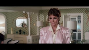 Movie still from “Superman IV: The Quest for Peace” (1987), directed by Sidney J. Furie – A woman wearing a pink jacket in a room with green walls; Medium shot, Over the shoulder angle