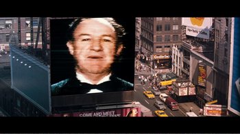Movie still from “Superman IV: The Quest for Peace” (1987), directed by Sidney J. Furie – An image of an older man on a large screen; Medium shot, High angle