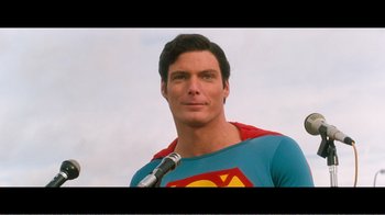 Movie still from “Superman IV: The Quest for Peace” (1987), directed by Sidney J. Furie – A person wearing a superman shirt; Close Up shot, Over the shoulder angle