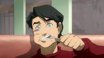 Movie still from “Superman/Shazam!: The Return of Black Adam” (2010), directed by Joaquim Dos Santos – A man is brushing his teeth while sitting on a chair; Close Up shot, High angle
