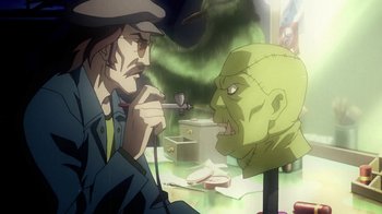 Movie still from “Superman/Shazam!: The Return of Black Adam” (2010), directed by Joaquim Dos Santos – A man is painting a face of a green monster; Medium shot, Over the shoulder angle