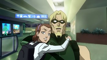 Movie still from “Superman/Shazam!: The Return of Black Adam” (2010), directed by Joaquim Dos Santos – A woman and a man are standing next to each other in a room; Medium shot, Over the shoulder angle