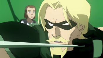 Movie still from “Superman/Shazam!: The Return of Black Adam” (2010), directed by Joaquim Dos Santos – A man with blonde hair holding a sword; Close Up shot, Over the shoulder angle