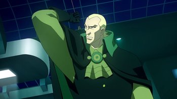Movie still from “Superman/Shazam!: The Return of Black Adam” (2010), directed by Joaquim Dos Santos – A man in a green outfit is holding a cell phone; Medium shot, Low angle