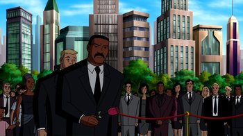 Movie still from “Superman: Doomsday” (2007), directed by Bruce Timm – A man in a suit and tie standing in front of a group of people; Wide shot, Low angle