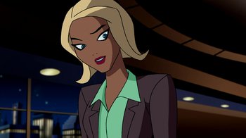 Movie still from “Superman: Doomsday” (2007), directed by Bruce Timm – A woman with blonde hair wearing a green shirt; Medium shot, Over the shoulder angle