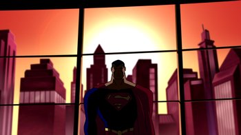 Movie still from “Superman: Doomsday” (2007), directed by Bruce Timm – A man in a superman costume standing in front of a window; Extreme Wide shot, Low angle