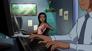 Movie still from “Superman: Doomsday” (2007), directed by Bruce Timm – An animated woman sitting in front of a computer keyboard; Medium shot, Over the shoulder angle