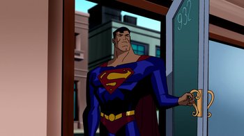 Movie still from “Superman: Doomsday” (2007), directed by Bruce Timm – A man standing in front of a building with his hands on his hips; Medium shot, Over the shoulder angle