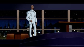 Movie still from “Superman: Doomsday” (2007), directed by Bruce Timm – A man in a white suit standing in front of a window at night; Wide shot, Over the shoulder angle