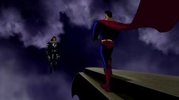 Movie still from “Superman: Doomsday” (2007), directed by Bruce Timm – A man standing on top of a building next to another man; Wide shot, Low angle