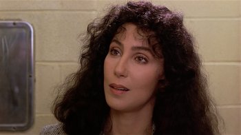 Movie still from “Suspect” (1987), directed by Peter Yates – A person with long curly hair; Close Up shot, High angle