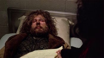 Movie still from “Suspect” (1987), directed by Peter Yates – A man with long hair laying in a hospital bed; Medium shot, High angle