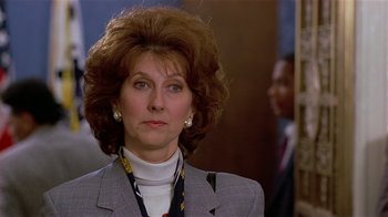 Movie still from “Suspect” (1987), directed by Peter Yates – A person wearing a suit and tie; Close Up shot, Low angle