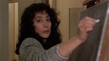 Movie still from “Suspect” (1987), directed by Peter Yates – A person with long curly hair; Close Up shot, Over the shoulder angle