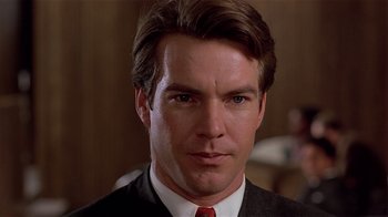 Movie still from “Suspect” (1987), directed by Peter Yates – A person wearing a suit and red tie; Close Up shot, Low angle