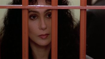 Movie still from “Suspect” (1987), directed by Peter Yates – A person behind a fence; Close Up shot, High angle