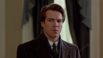 Movie still from “Suspect” (1987), directed by Peter Yates – A person wearing a suit and tie; Close Up shot, Over the shoulder angle