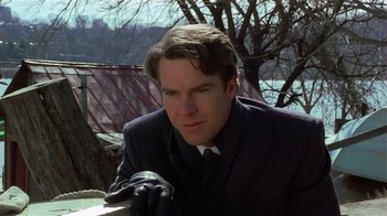 Movie still from “Suspect” (1987), directed by Peter Yates – A person wearing a suit and tie; Close Up shot, Over the shoulder angle