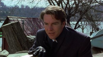 Movie still from “Suspect” (1987), directed by Peter Yates – A person wearing a suit and tie; Close Up shot, Low angle