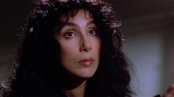 Movie still from “Suspect” (1987), directed by Peter Yates – A person with long curly hair; Close Up shot, High angle