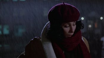 Movie still from “Suspect” (1987), directed by Peter Yates – A woman wearing a red hat and scarf in the rain; Close Up shot, Low angle