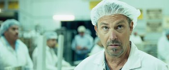 Movie still from “Swing Vote” (2008), directed by Joshua Michael Stern – A person wearing a lab coat; Close Up shot, Over the shoulder angle