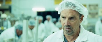 Movie still from “Swing Vote” (2008), directed by Joshua Michael Stern – A man in a lab coat and a group of people in the background; Close Up shot, Over the shoulder angle