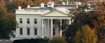 Movie still from “Swing Vote” (2008), directed by Joshua Michael Stern – A white house with columns in front of trees and a hill; Extreme Wide shot, Low angle