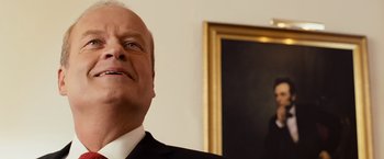 Movie still from “Swing Vote” (2008), directed by Joshua Michael Stern – A man in a suit and tie looking up at the ceiling; Close Up shot, Low angle